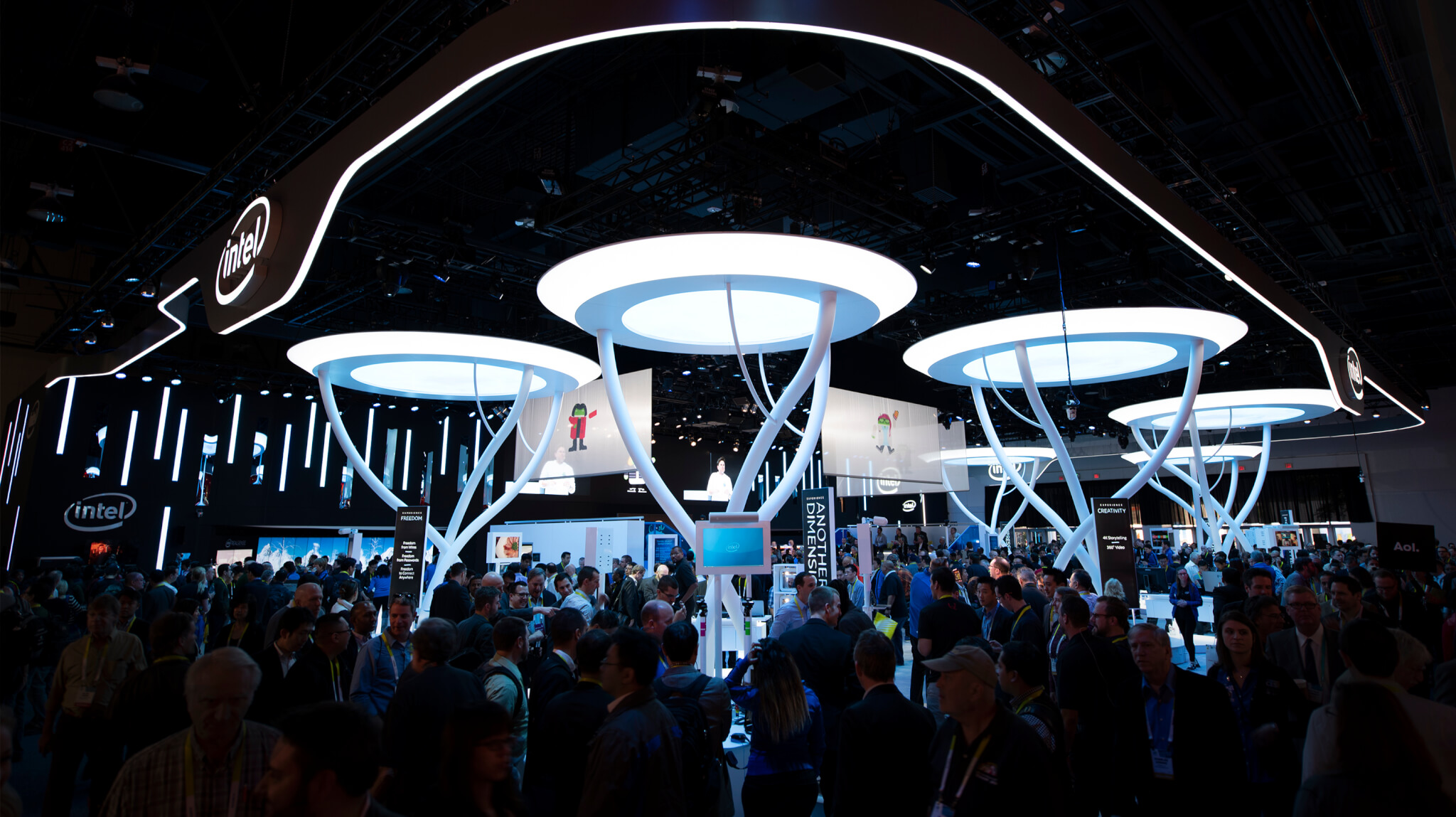 A crowd gathers around RealSense, an immersive experiential trade show exhibit.