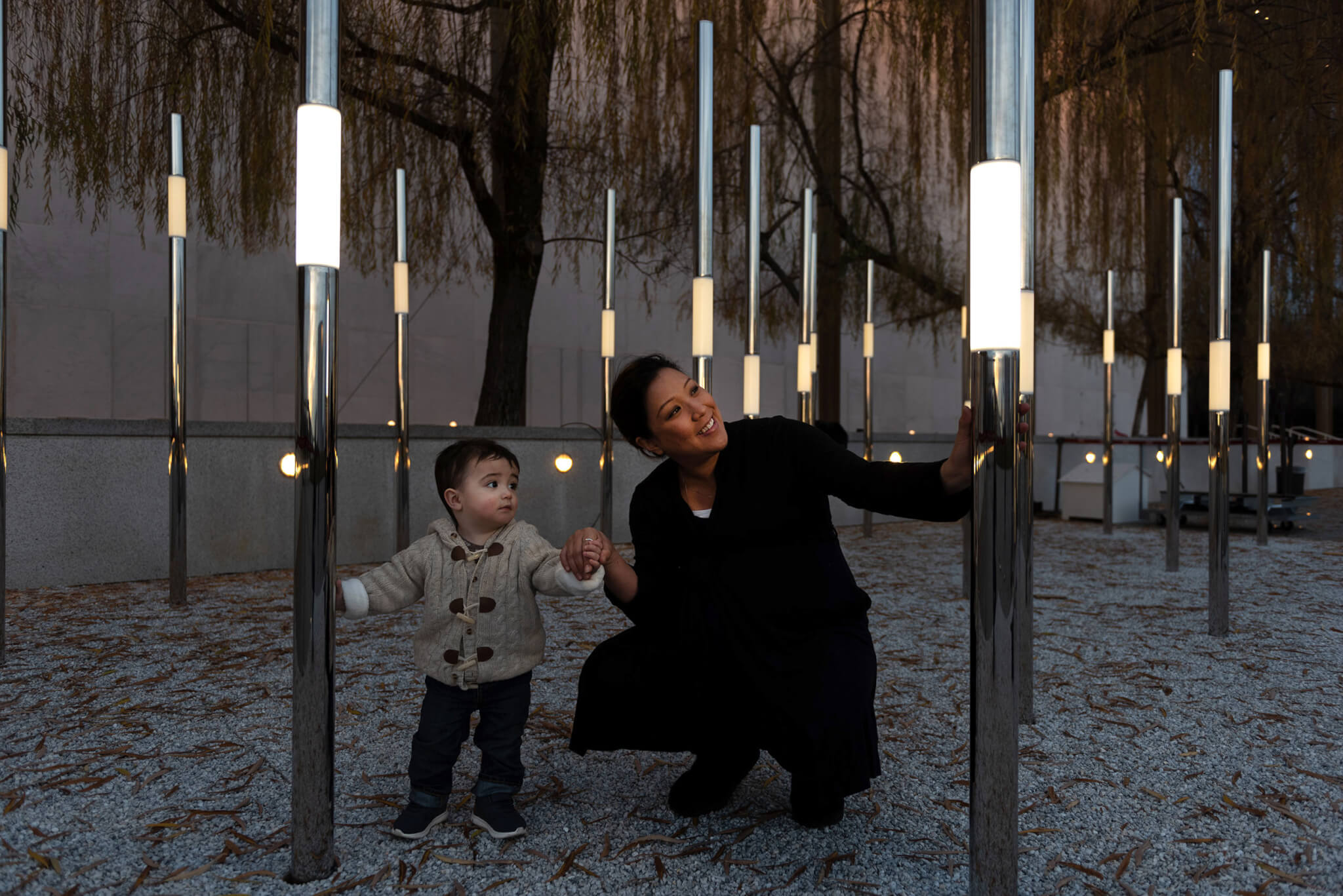 A mother and adorable baby interact with Heartfelt, an interactive permanent outdoor sculpture.
