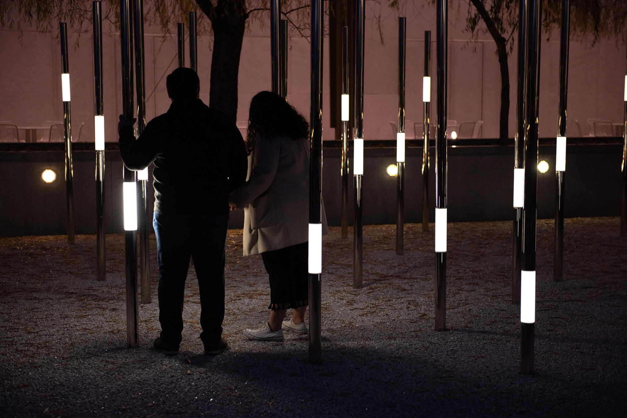 A man and woman interact with Heartfelt, an interactive permanent outdoor sculpture.
