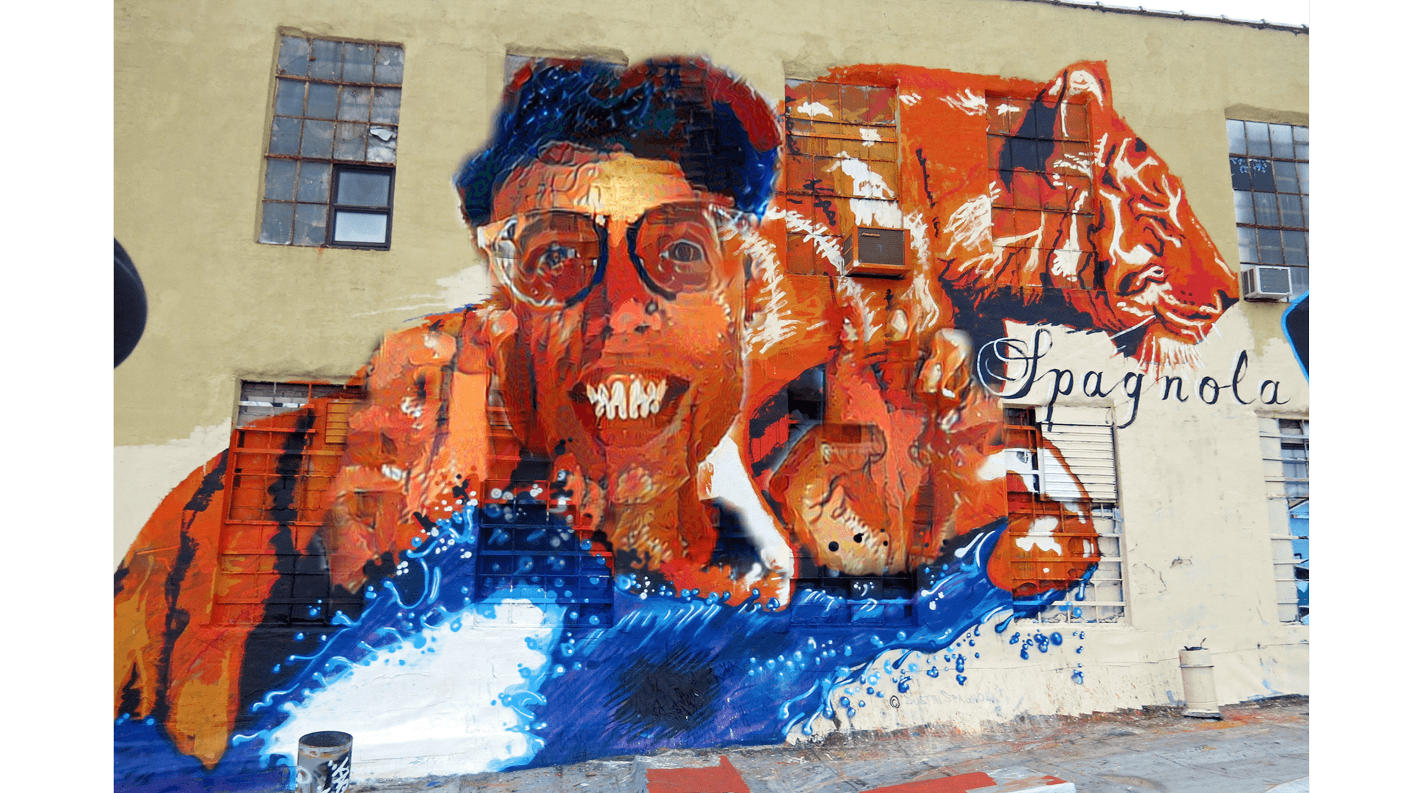 An LCD graffiti artwork paints a woman into a 5Pointz mural of a tiger.